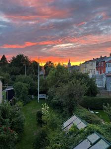 a view of a city with a sunset in the background at Townhouse in Odense