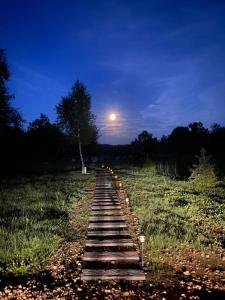 a path in the middle of a field at night at River House Moon in Gospić