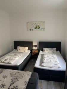two twin beds in a room with a couch at Bronzetaler in Bad Harzburg