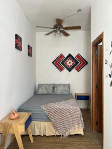 a bedroom with a bed and a ceiling fan at Cerro Beach in Sinchal