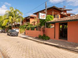 a street with a car parked in front of a building at Pousada Atiaia in Ilhabela