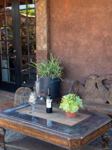 a table with a bottle of wine and a glass at Posada Balaprada in Ensenada