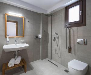 a bathroom with a shower and a sink and a toilet at Melia Villas in Ierissos