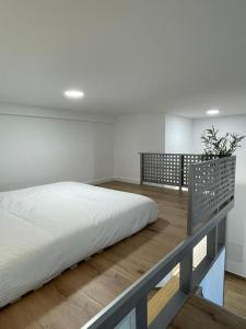 a large bed in a room with at MiniLoft Baiona COM - in Baiona