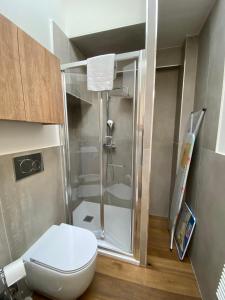 a small bathroom with a shower and a toilet at Hostdomus - G10 Suite in Turin