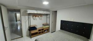 a bedroom with a bed and a walk in closet at Ótimo apartamento com wi-fi gratuito in Guarapari