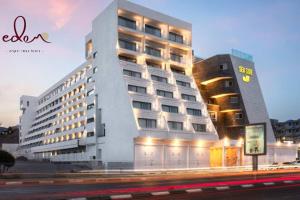 a large building with a sign on the side of it at דירה יוקרתית 100 מטר מהים - By Edomlux in Eilat