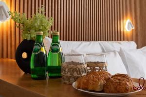 a table with two bottles and a plate of pastries at Luxury living 100 meter from the beach - by Edom in Eilat