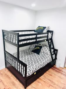 a black bunk bed with two pillows on it at Modern Brownstone 2bdrm Duplex with Backyard terrace in Brooklyn