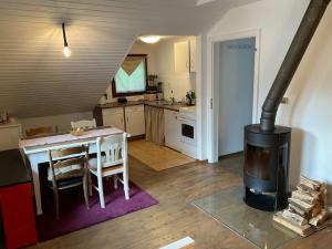 a kitchen with a table and a wood stove at Wohnung in idyllischem Örtchen in Meschede