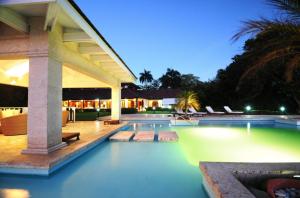 a swimming pool with lights in a house at Sunny Vacation Villa No 51 in San Rafael del Yuma