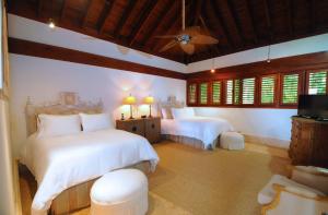 a bedroom with two beds and a flat screen tv at Sunny Vacation Villa No 51 in San Rafael del Yuma