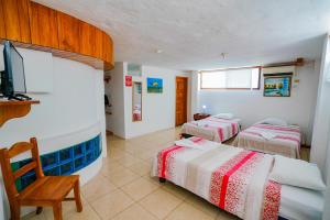 Postel nebo postele na pokoji v ubytování Galapagos Verde Azul