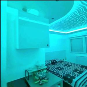 a room with a bed with blue lights on it at Bron centre appartement meublé avec jacuzzi in Bron