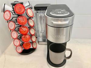 a coffee maker with a cup on a counter at Luxe Corner Penthouse 1BR Condo on Sunset in Los Angeles
