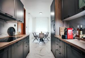 a kitchen with a table and a counter top at Apartman STRONG in Slavonski Brod