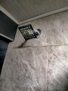 a trash can sitting on the floor of a bathroom at Casa Hospedaje - H in Bogotá