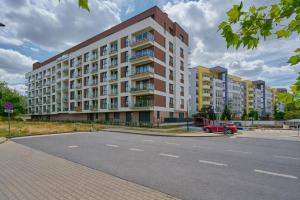 a large apartment building on the side of a street at Lwowska Apartment by the Malta Lake with Parking by Renters Prestige in Poznań