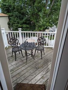 a patio with two chairs and a table on a deck at Wonderful & Cozy Apartment Close to Time Square NYC in North Bergen