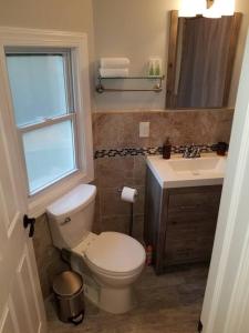 a bathroom with a toilet and a sink at Wonderful & Cozy Apartment Close to Time Square NYC in North Bergen