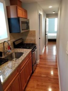 a kitchen with a sink and a stove at Wonderful & Cozy Apartment Close to Time Square NYC in North Bergen