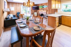 a kitchen and living room with a wooden table and chairs at CB-5515 - Walk to Beach - Private Hot Tub - Ideal Location in Carlsbad