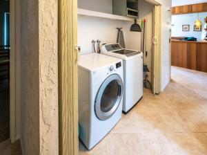 a washer and dryer in a room with a kitchen at CB-5515 - Walk to Beach - Private Hot Tub - Ideal Location in Carlsbad