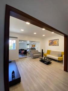 a large living room with a couch and a table at Friendly house in Funchal