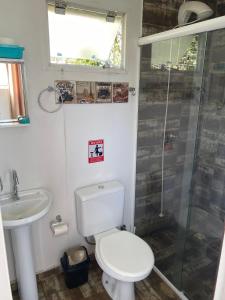 a bathroom with a toilet and a sink and a shower at Casa Container Praia do Rosa - 01 Ibiraquera in Imbituba