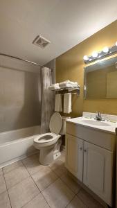 a bathroom with a toilet and a sink at B'more Inn Motel in Baltimore