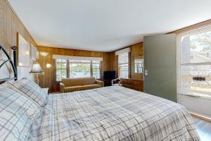 a bedroom with a bed and a chair and a window at King Birch Lake Home, Unit 10 in Alton