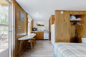 ein Schlafzimmer mit einem Bett und eine Küche mit einem Waschbecken in der Unterkunft King Birch Lake Home, Unit 10 in Alton