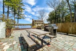 a picnic table and a grill on a patio at King Birch Lake Home, Unit 10 in Alton