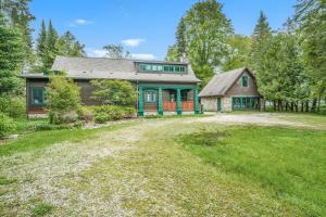 a large house with a yard in front of it at Platte Lake Paradise in Beulah