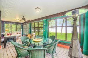 a dining room with a glass table and chairs at Platte Lake Paradise in Beulah