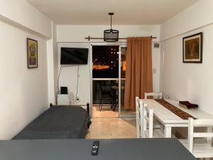 Habitación pequeña con cama, mesa y ventana en A&B Apartment en Salta