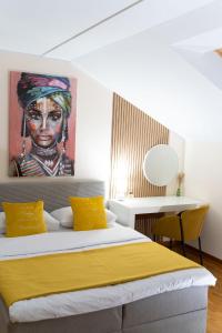 a bedroom with a bed with a painting on the wall at Mini Hotel RiverLux Apartments in Bačka Palanka