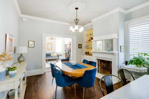 a dining room with a table and chairs and a fireplace at Historic Savannah Home with Outdoor Grill, Patio in Savannah