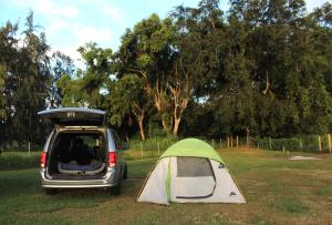 a tent and a van parked in a field at Maleka Farm Camper-Vans in Laie