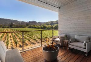 a porch with chairs and a view of a vineyard at Alila Napa Valley, a Hyatt Resort in St. Helena