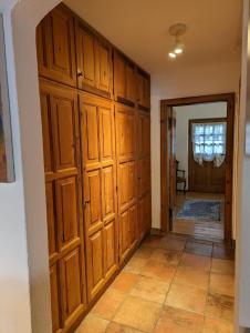 a hallway with wooden cabinets in a house at Herzstuecke-Ferienwohnung in Ingenried