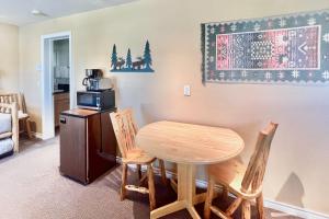 a kitchen with a table and chairs and a microwave at On the Rapids - A Unit in Grand Lake
