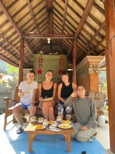 a group of people sitting around a table at MALINI Homestay in Ubud