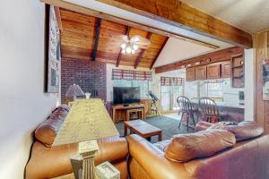 a living room with leather couches and a kitchen at Evergreen #B4 in Brian Head