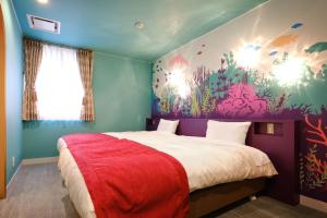 a bedroom with a bed with a fish mural on the wall at Four Stories Hotel Maihama Tokyo Bay in Urayasu