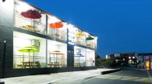 a building with umbrellas on the side of it at Suncheon Bay Ecology Pension in Suncheon