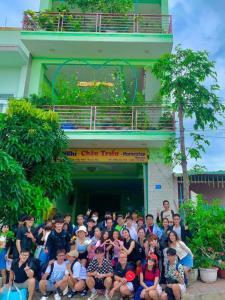 a group of people posing for a picture in front of a building at Homestay Châu Triều - Phan Thiết in Phan Thiet