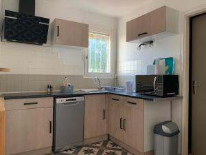 a kitchen with a sink and a dishwasher at Duplex Centre Ville 3 chambres in Alès