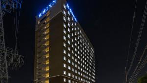 a tall building with blue lights on top of it at Toyoko Inn Kita-toda-eki Higashi-guchi in Toda +33 photos