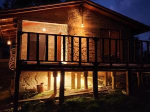 a house with lights on the outside of it at cabaña el rio 2 in Zacatlán +8 photos